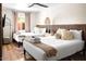 Cozy bedroom with two beds, decorative pillows, and natural light from the window at 8734 E Amelia Ave, Scottsdale, AZ 85251