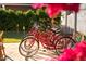 Red bicycles sit next to an outdoor putting green, perfect for recreation and enjoying the weather at 8734 E Amelia Ave, Scottsdale, AZ 85251
