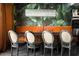 Chic dining area with a long table, decorative wallpaper, and statement lighting at 8734 E Amelia Ave, Scottsdale, AZ 85251