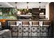 Stylish bar with designer tile, seating, and unique pendants creates a chic entertaining space at 8734 E Amelia Ave, Scottsdale, AZ 85251
