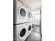Functional laundry room with stacked washer and dryer; opens into bathroom at 8734 E Amelia Ave, Scottsdale, AZ 85251