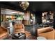 Open living room with a modern chandelier, wet bar, and ample seating for guests at 8734 E Amelia Ave, Scottsdale, AZ 85251