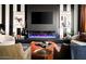 Stylish living room with a black accent wall, fireplace, and comfortable seating at 8734 E Amelia Ave, Scottsdale, AZ 85251