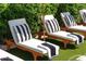 Outdoor lounge chairs with black and white striped pillows and towels provide stylish poolside relaxation at 8734 E Amelia Ave, Scottsdale, AZ 85251