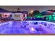 Expansive outdoor living space featuring a built-in lounge, fire pit, and bar area for entertaining guests at 8734 E Amelia Ave, Scottsdale, AZ 85251