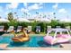Backyard pool with fun floats, lounge chairs, and umbrellas creates a playful summer vibe at 8734 E Amelia Ave, Scottsdale, AZ 85251