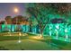 Beautiful backyard putting green with lush landscaping and exterior lighting for evening use at 8734 E Amelia Ave, Scottsdale, AZ 85251