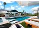 Relaxing pool with in-water loungers, poolside seating, and a lush tropical landscape, perfect for enjoying the outdoors at 8734 E Amelia Ave, Scottsdale, AZ 85251