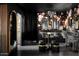 Close up of a glam vanity area with custom lighting, mirrors, and floral wallpaper at 8734 E Amelia Ave, Scottsdale, AZ 85251