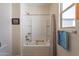Bright bathroom with a shower/tub combo, framed art, and a window for natural light at 10035 E Trent Ave, Mesa, AZ 85212