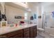 Bright bathroom with double sinks, wood cabinets, and a shower/tub combo at 10035 E Trent Ave, Mesa, AZ 85212