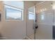 Modern bathroom featuring a glass-enclosed shower and window with neighborhood views at 10035 E Trent Ave, Mesa, AZ 85212