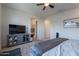Relaxing bedroom featuring ceiling fan, plush carpet, and modern furnishings at 10035 E Trent Ave, Mesa, AZ 85212