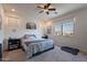 Bright bedroom features a ceiling fan, neutral tones and a large window with neighborhood views at 10035 E Trent Ave, Mesa, AZ 85212