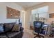 Bright bedroom featuring a leather sofa, desk, and a large window for natural light at 10035 E Trent Ave, Mesa, AZ 85212