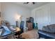This bedroom is set up as an office with a desk, laptop, and a rolling office chair at 10035 E Trent Ave, Mesa, AZ 85212