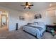 Serene bedroom featuring neutral walls, ceiling fan, plush carpet, and large windows at 10035 E Trent Ave, Mesa, AZ 85212