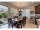 Charming dining room featuring a stylish chandelier and sliding glass doors to the backyard at 10035 E Trent Ave, Mesa, AZ 85212