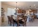 Dining area with a dark wood table, chandelier, and easy access to the kitchen at 10035 E Trent Ave, Mesa, AZ 85212