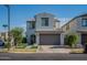 Two-story home featuring a gray garage door, neutral color scheme and low-maintenance landscaping at 10035 E Trent Ave, Mesa, AZ 85212