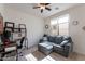 Inviting home office featuring a comfortable couch and a work desk with shelving at 10035 E Trent Ave, Mesa, AZ 85212
