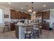 Eat-in kitchen with a granite-topped island, stainless steel appliances, and wood cabinetry at 10035 E Trent Ave, Mesa, AZ 85212