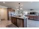 Eat-in kitchen featuring stainless steel appliances, a granite-topped center island and an open floor plan at 10035 E Trent Ave, Mesa, AZ 85212