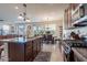 Open concept kitchen featuring stainless steel appliances, dark cabinets and a spacious dining area at 10035 E Trent Ave, Mesa, AZ 85212