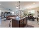 Open concept kitchen with a granite-topped island, stainless steel appliances and an eat-in area at 10035 E Trent Ave, Mesa, AZ 85212
