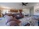 Spacious living room with a large sectional sofa, open floor plan and access to the eat-in kitchen at 10035 E Trent Ave, Mesa, AZ 85212