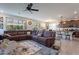 Open living space with tile flooring, a leather sectional sofa, and plenty of natural light at 10035 E Trent Ave, Mesa, AZ 85212