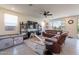Cozy living room with a ceiling fan, tile floors, and a large window that brings in natural light at 10035 E Trent Ave, Mesa, AZ 85212