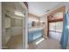 Inviting bathroom featuring double sinks, a walk-in closet, and tile floors at 10371 W Pontiac Dr, Peoria, AZ 85382