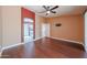 Large bedroom with dark wood flooring, fan, and ensuite bathroom. This room offers easy access to personal amenities at 10371 W Pontiac Dr, Peoria, AZ 85382