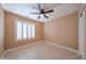 Cozy bedroom showcasing plantation shutters and neutral walls at 10371 W Pontiac Dr, Peoria, AZ 85382