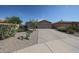Single-story home with desert landscaping, two-car garage, and concrete driveway at 10371 W Pontiac Dr, Peoria, AZ 85382
