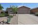 Single-story home with desert landscaping, a two-car garage, and a long concrete driveway at 10371 W Pontiac Dr, Peoria, AZ 85382