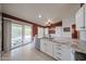 Bright kitchen with marble countertops, stainless steel dishwasher, and backyard view through sliding glass doors at 10371 W Pontiac Dr, Peoria, AZ 85382