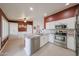 Kitchen with stainless steel appliances, a central island, and white cabinetry for ample storage and counter space at 10371 W Pontiac Dr, Peoria, AZ 85382