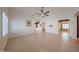 Open living space with neutral tile flooring, vaulted ceilings, and plenty of natural light at 10371 W Pontiac Dr, Peoria, AZ 85382