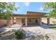 Back patio featuring a covered space, ceiling fan, exterior lighting, gravel, and low-maintenance landscaping at 10371 W Pontiac Dr, Peoria, AZ 85382