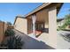 Side view of the covered patio featuring privacy curtains and desert landscaping at 10371 W Pontiac Dr, Peoria, AZ 85382