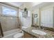 Well-lit bathroom featuring a granite vanity, bathtub, and window with bright natural light at 10401 N 52Nd St # 205, Paradise Valley, AZ 85253