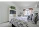 Bright bedroom with a white bed frame, television on shelving unit, and a large window at 10401 N 52Nd St # 205, Paradise Valley, AZ 85253