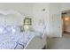 Bright bedroom featuring a white bed frame, ceiling fan, and decorative accents at 10401 N 52Nd St # 205, Paradise Valley, AZ 85253