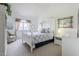 Bright bedroom featuring a white bed frame, ceiling fan, bedside table, and decorative accents at 10401 N 52Nd St # 205, Paradise Valley, AZ 85253