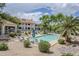 Relaxing community pool area featuring lounge chairs, umbrellas, and lush landscaping for a resort-like experience at 10401 N 52Nd St # 205, Paradise Valley, AZ 85253
