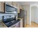 Efficient kitchen with stainless steel appliances, stylish countertops, and convenient layout at 10401 N 52Nd St # 205, Paradise Valley, AZ 85253