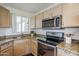 Well-equipped kitchen with stainless steel appliances, granite countertops, and ample cabinet space at 10401 N 52Nd St # 205, Paradise Valley, AZ 85253