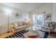 Bright living room featuring a comfortable couch, glass coffee table, and sliding doors to the patio at 10401 N 52Nd St # 205, Paradise Valley, AZ 85253